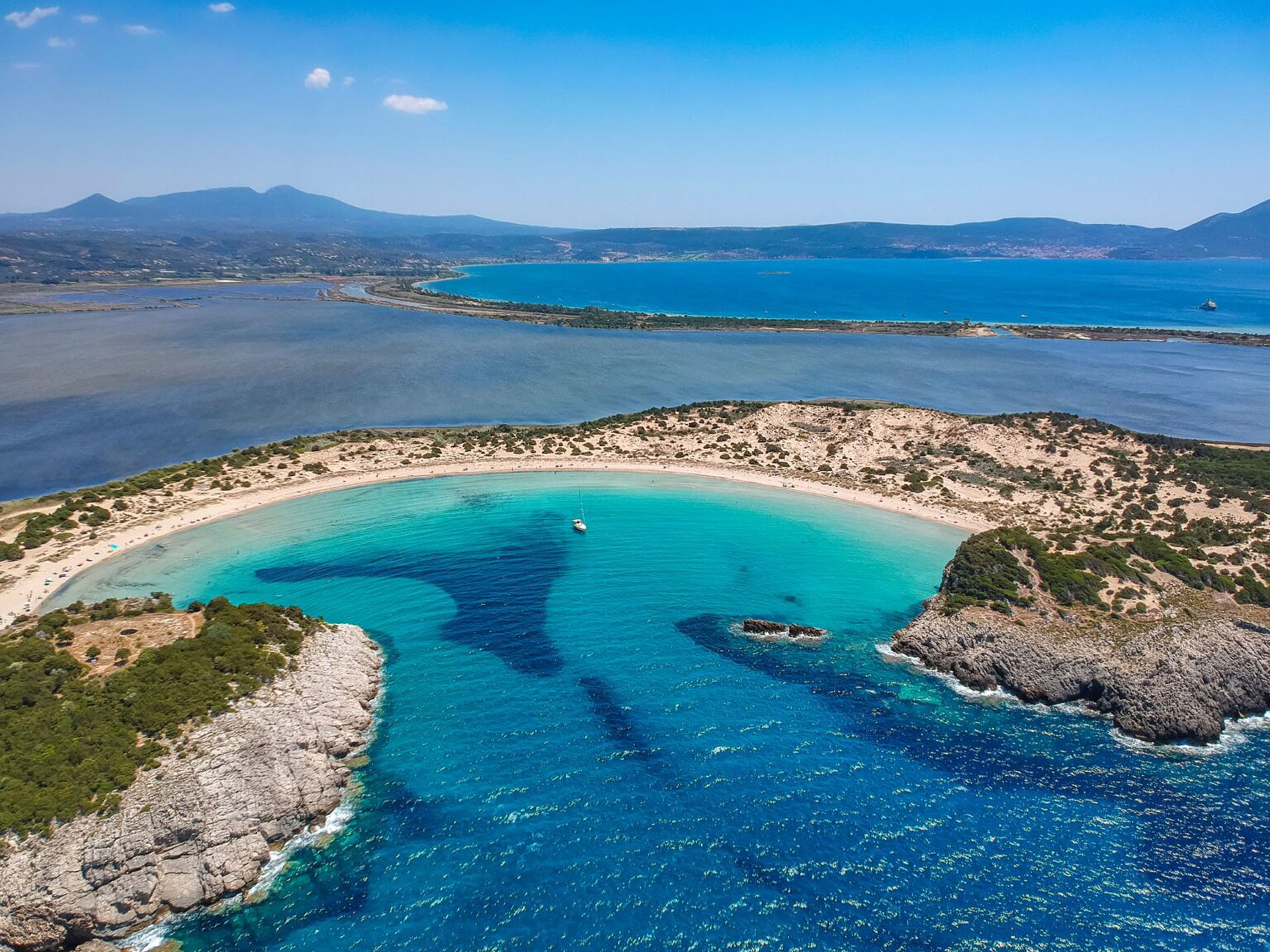 beach and lagoon of Voidokilia. It is one of the most iconic beaches in Mediterranean sea with crystal clear turquoise water in Messenia, Greece